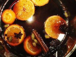 Mulled wine in a pot with spices and slices of orange